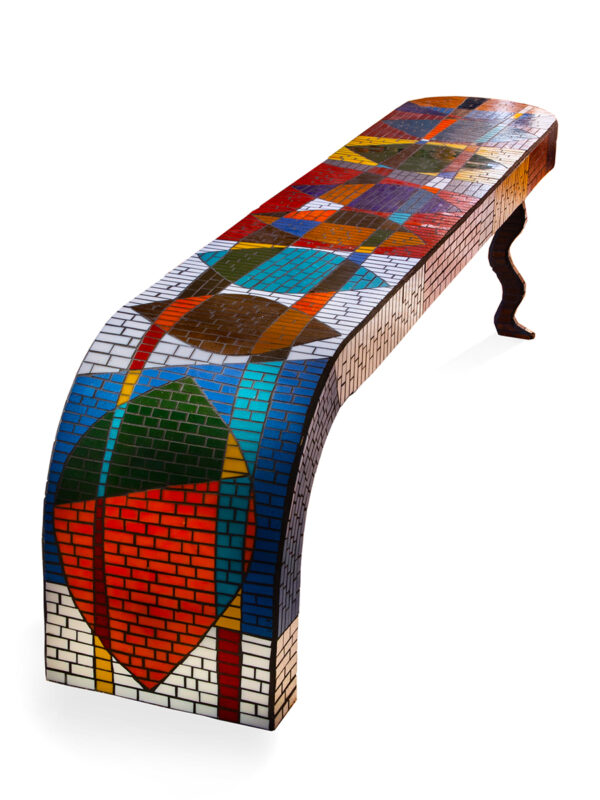 Colorful mosaic bench with curved design.
