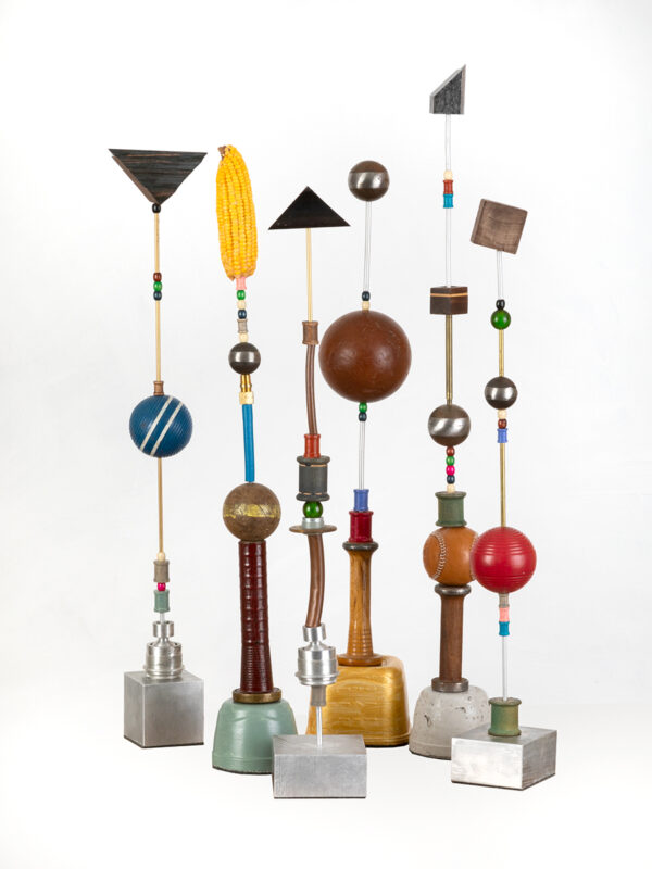 Colorful geometric sculptures on white background.